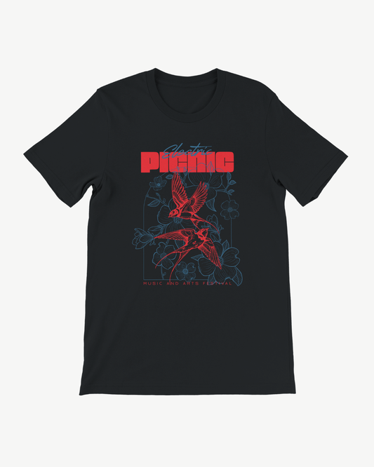 The 2026 Neon Nature Event T Shirt by Electric Picnic is a black, eco-friendly, made-to-order tee featuring a red and blue graphic of birds, flowers, and a skull. Red text at the top reads “PICNIC,” with “Music and Arts Festival” printed below. Designed with a unisex tailored fit for maximum comfort and style.