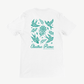 The Floral Swallows T Shirt by Electric Picnic features teal bird, flower, and leaf illustrations on the back, with “Electric Picnic Music and Arts Festival” printed below. This eco-friendly, made-to-order tee offers a unisex tailored fit for both comfort and style.