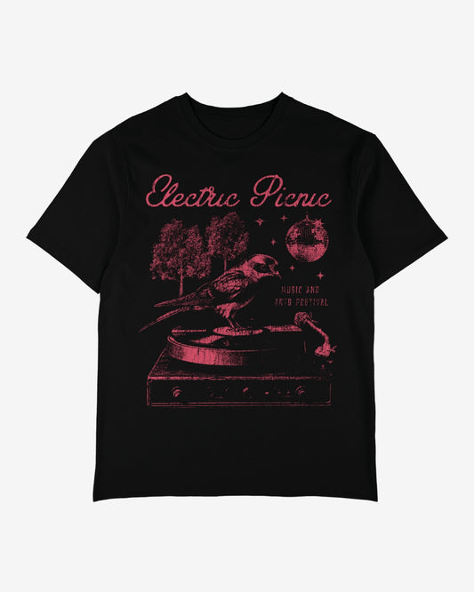 The Record Player T-shirt by Electric Picnic is a black tee with pink artwork featuring a bird on a vinyl player, trees, a disco ball, and the text Electric Picnic and Music and Arts Festival.