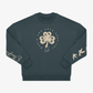 The EP 2026 Click & Collect "Click & Collect Vintage Clover Crewneck 2" features a dark green color with a cream four-leaf clover and "Music and Arts Festival" text on the front. Birds and cursive writing decorate the sleeves, all displayed against a plain white background.