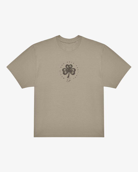 The Click & Collect Vintage Clover Oversized T-Shirt by EP 2026 Click & Collect features a beige short-sleeve design with a black four-leaf clover graphic and circular text on the chest, along with a small curved line or signature beneath the clover.